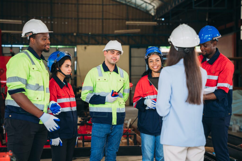 Engineers and foreman inspecting and meeting about the automated arms machine welding robots at factory machines. Worker industry working in the manufacture industrial.