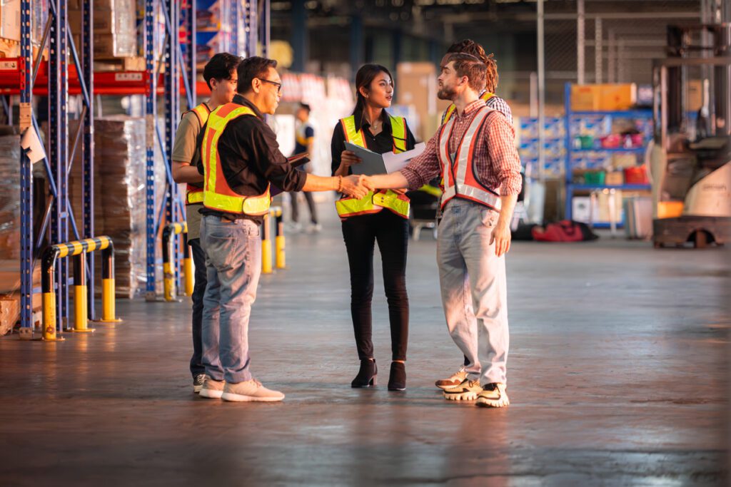A group of warehouse employees, Inspecting products on warehouse shelves before they are sent to retailer