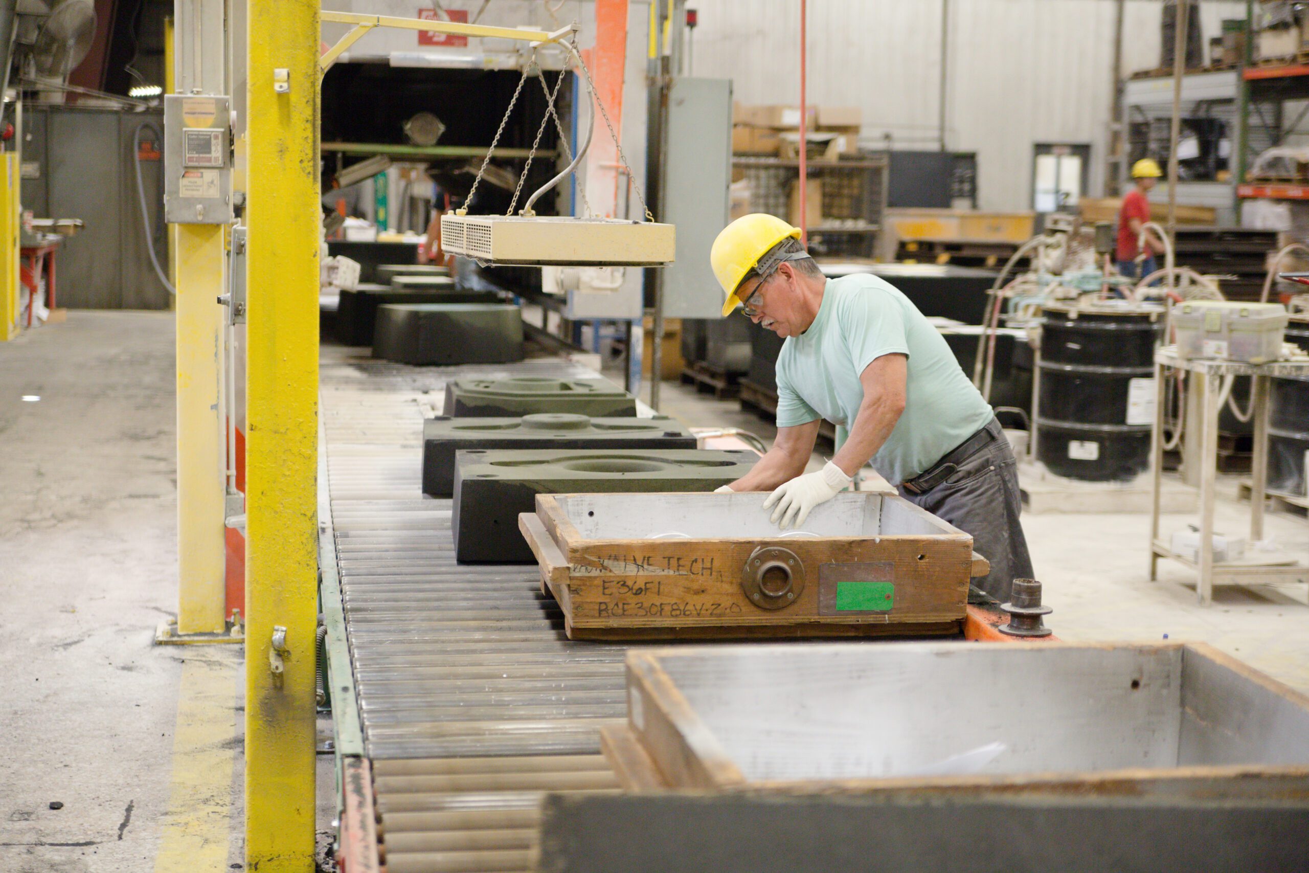 Employee inspects parts in a manufacturing facility