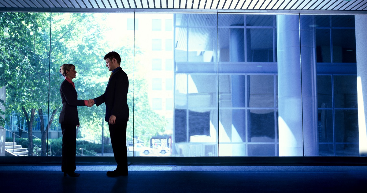 People meeting in dark hallway