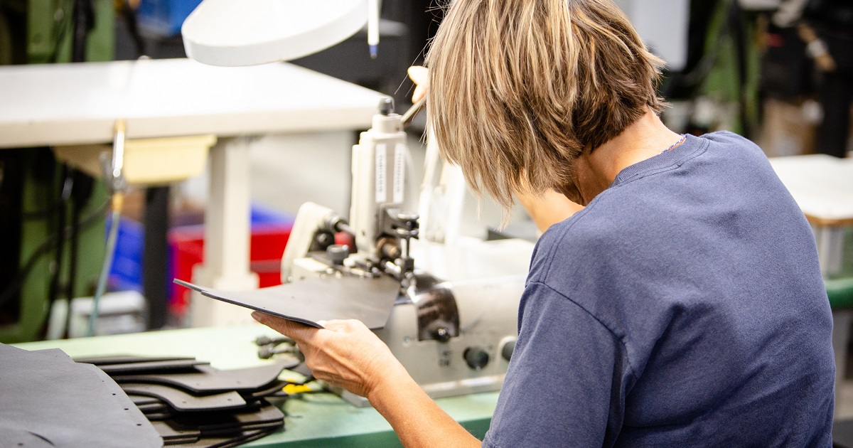 Employee works on sewing machine