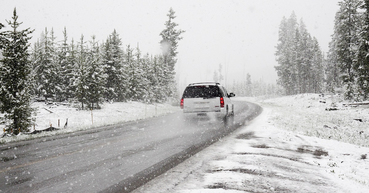 SUV drives on snowy road
