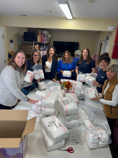 A group of female employees wrap diapers.
